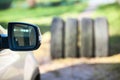 Side mirror of car against four tyres, seasonal wheel and tire changing Royalty Free Stock Photo