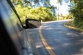 The side mirror of the car while the car ran into the curve of mountain Royalty Free Stock Photo