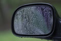 Side mirror of a car with drops from rain Royalty Free Stock Photo