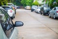 A side mirror car with rain drop after rain fall with many car parking on village road in working day while lockdown from covid