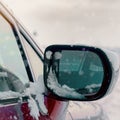 A side mirror of a car in the snow on a winter day Royalty Free Stock Photo