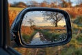 Serene Countryside Reflected in a Car\'s Side Mirror at Sunrise Royalty Free Stock Photo
