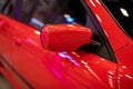 The side mirror of a red sports car. Rear-view mirror Royalty Free Stock Photo