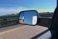 Side mirror showing travel trailer being pulled Royalty Free Stock Photo