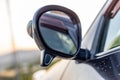 Side mirror of a vehicle with a secondary blind spot assistance mirror closeup with selective focus