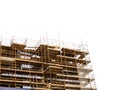 Side of a new building in scaffolding and safety nets. Construction site safety measures. Developing commercial or residential Royalty Free Stock Photo