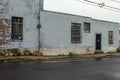 Side of old vintage warehouse building painted light blue