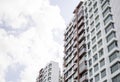 Side part of a condominium with clear blue sky and white clouds Royalty Free Stock Photo