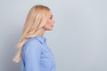 Side photo of confident blonde curly lady boss mature expert look empty space work life balance concept isolated on grey