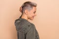 Side photo of woman wear khaki shirt touch stylish new hairdo blonde short cut touch stroke back head isolated on beige