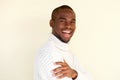 Side portrait of attractive african american man in sweater smiling against light background