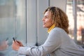 Beautiful african american woman holding mobile phone and looking up Royalty Free Stock Photo