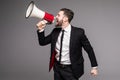 Side portrait Business man screaming with a megaphone Royalty Free Stock Photo