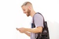 Cool young guy with beard looking at mobile phone Royalty Free Stock Photo