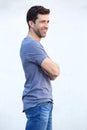 Handsome young man standing with arms crossed against white wall Royalty Free Stock Photo