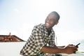 Side portrait happy african american man using mobile phone outside Royalty Free Stock Photo