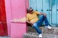 Side portrait older man leaning against the wall