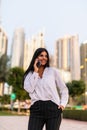 Portrait of a professional business woman smiling with mobile phone outside in the street Royalty Free Stock Photo