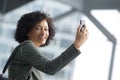 Side portrait of smiling african american woman with mobile phone Royalty Free Stock Photo