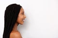 Side portrait of smiling african young woman with braids on white background Royalty Free Stock Photo