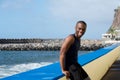 Sporty african american man leaning against wall by sea Royalty Free Stock Photo