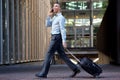 Side portrait of traveling businessman talking on cellphone Royalty Free Stock Photo