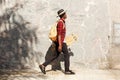 Side portrait of young african american man walking outside with skateboard Royalty Free Stock Photo