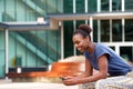 Side portrait of young african american woman looking at mobile phone outdoors Royalty Free Stock Photo