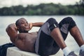 Side portrait of a young black man doing sit ups Royalty Free Stock Photo