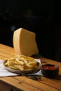 A side of potato fries with tomato sauce and cheese.