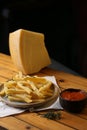 A side of potato fries with tomato sauce and cheese.