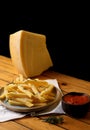 A side of potato fries with tomato sauce and cheese.