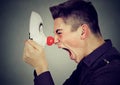 Side profile angry man screaming at happy clown mask Royalty Free Stock Photo