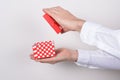 Side profile close up photo portrait of hands holding open unpack unwrap present box in hands isolated grey background