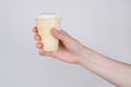 Side profile cropped close up photo of hand getting holding sharing taking waffle cup with ice cream isolated grey background