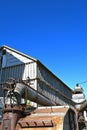 The top of an old threshing machine displays the blower pipe. Royalty Free Stock Photo