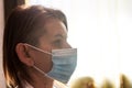 Side profile of a female doctor wearing a white stethoscope lab coat and protective mask for covid 19 Royalty Free Stock Photo