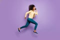 Side profile full length body size photo of casual positive running jumping funky crazy girl in pants trousers yellow Royalty Free Stock Photo