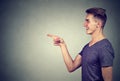 Side profile of a laughing young man pointing finger at someone Royalty Free Stock Photo
