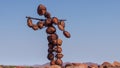 Side profile of a lone stone man walking to a big gathering. These lone men are a mystery found in the northern Kaokoveld of