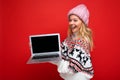 side profile photo of charming smiling happy pretty young woman holding laptop isolated over red wall background looking Royalty Free Stock Photo