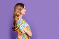 Side profile photo of confident youth blonde wavy hair lady looking empty space hairdresser salon isolated on violet