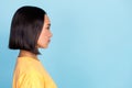 Side profile photo of young attractive adorable pretty nice woman look serious empty space worker isolated on aquamarine Royalty Free Stock Photo