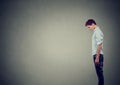 Side profile of a sad depressed young man looking down Royalty Free Stock Photo