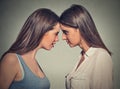 Side profile unhappy young female friends looking at each other Royalty Free Stock Photo