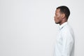 Side profile view of smart african young man looking aside isolated on gray background copyspace Royalty Free Stock Photo