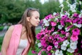 Side profile of young woman smelling blossoms Royalty Free Stock Photo