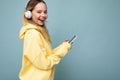 Side-ptofile closeup photo of beautiful smiling young woman wearing stylish casual outfit isolated over colorful Royalty Free Stock Photo