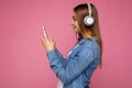 Side-ptofile closeup photo of beautiful young woman wearing stylish casual outfit isolated over colorful background wall Royalty Free Stock Photo