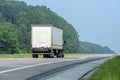 Side-Rear View of Eighteen Wheeler Going Down The Interstate